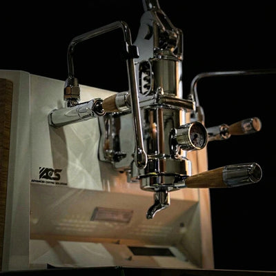 ACS Vostok One Group Espresso Machine close-up showing lever-operated mechanics and elegant design.
